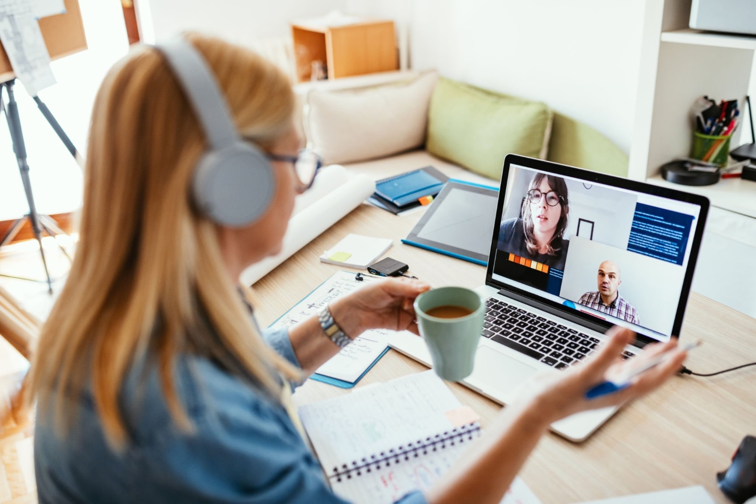Mature businesswoman working from home during pandemic and attending video call meeting